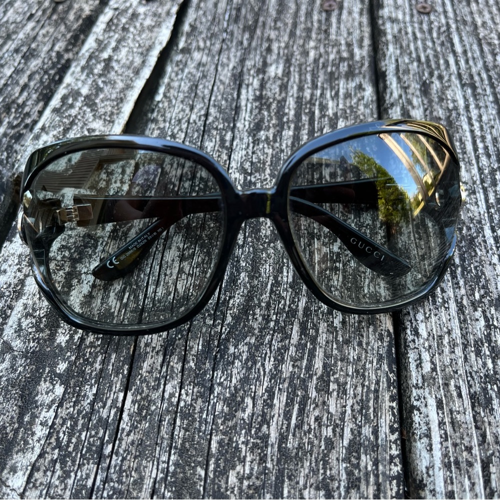 Black Gucci sunglasses with matching case